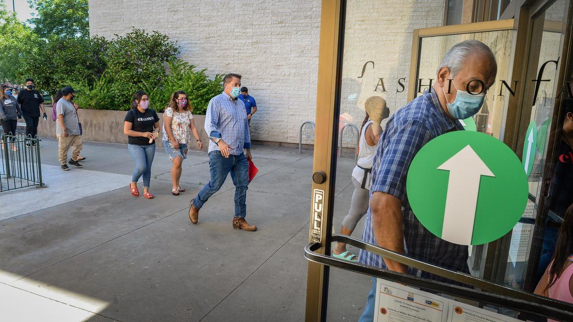 Customers file into the entrance at Fashion Fair mall when the doors opened on Tuesday, May 26, 2020, for the first time since late March due to the coronavirus pandemic.