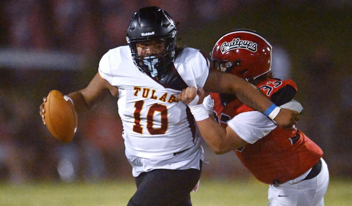 Hanford’s Jeremiah Valdez, right, tackles Tulare Union quarterback Jordan Crisp, left, in first half action Friday, Oct. 11, 2024 in Hanford.