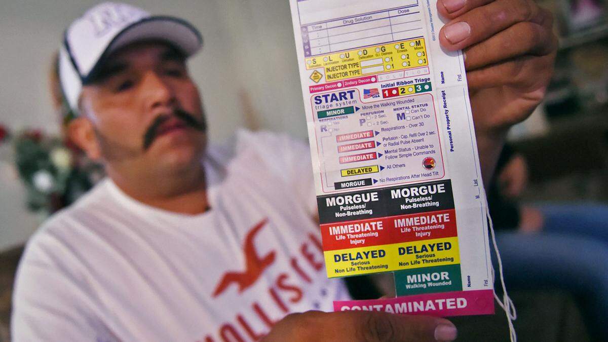 Mardonio Solorio, one of nearly 60 farm workers who were exposed to chemicals near a Dinuba vineyard, holds up a tag he wore hanging from his neck outlining his degree of exposure for medical personnel. Photographed Thursday, Sept. 5, 2019 in Fresno.