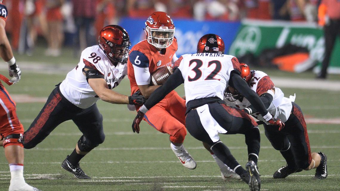 Fresno State quarterback Marcus McMaryion runs into a cluster of San Diego State defenders on a read-option play during a 23-14 victory over the Aztecs at Bulldog Stadium in Fresno on Saturday, Nov. 17, 2018. The Bulldogs’ victory clinched a division title and berth in the Mountain West Conference championship game.