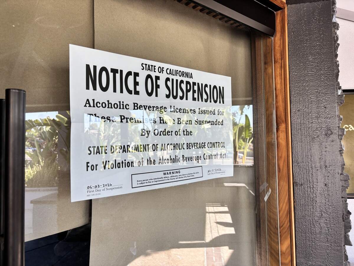 A notice of a 15-day suspension of a liquor license is posted on the door at Culichi Town in Fresno.