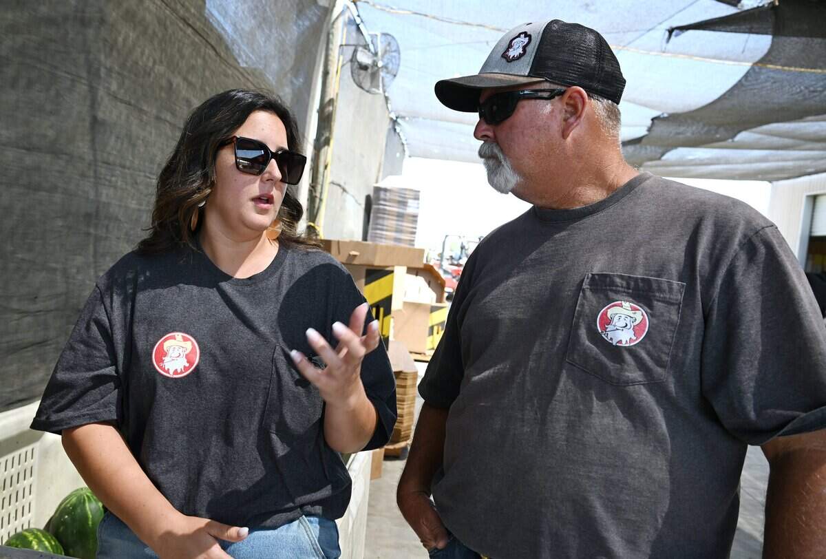 Jessica Allen, left, in charge of social media as well as the farm stand manager, talks about Dicky Don’s Watermelons with her father Richard Allen on Monday, June 15, 2026 near Sanger.