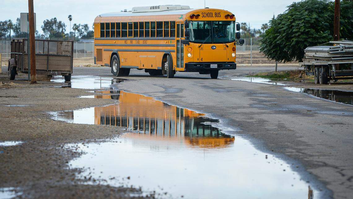 A West Park School District school bus turns onto South Prospect Avenue from West Church Avenue south west of Fresno on Monday, Oct. 25, 2021. Rural roads in Fresno County are neglected due to a county decision to not maintain them. That means potholes, flooding and basic safety measures go unfixed.