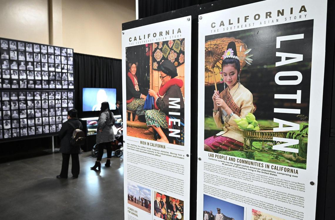 Visitors view VINAI, the Hmong Refugee Experience exhibit, a multimedia exhibit chronicling the Hmong community as they transitioned from their home country to refugee camps and finally the United States. The free exhibit is located in the Big Fresno Fair’s Commerce building now through Jan. 1, 2023. Photographed Friday, Dec. 23, 2022 in Fresno.