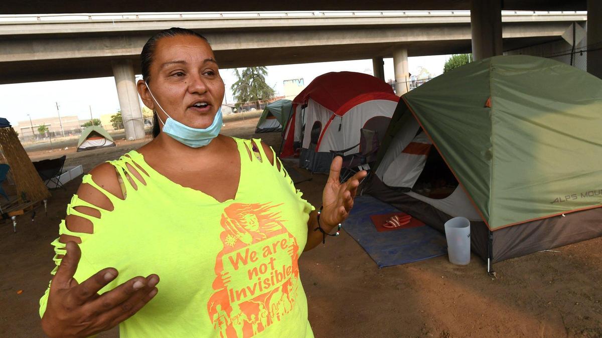 Under Highway 41 in downtown Fresno, homeless advocate Dez Martinez talks Thursday, Aug. 20, 2020, about the encampment she set up, named the Dream Camp by residents, to give homeless residents a safer and cleaner alternative to living on the streets. The camp operated for a year; Martinez closed it last fall.