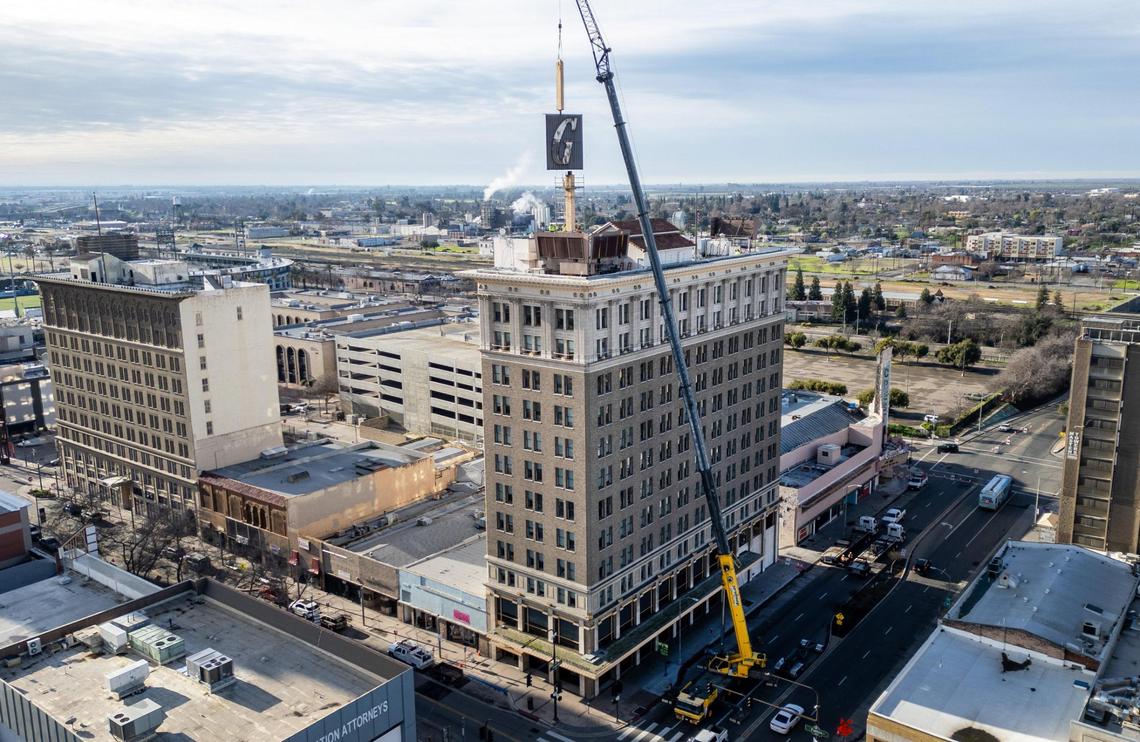 The Guarantee Bank G sign is finally lifted from its base on the Guarantee Bank building in downtown Fresno on Saturday, Feb. 3, 2024 after technical difficulties prevented the removal two weeks ago. The State Center Community College District, owners of the building, are replacing the historic sign with a replica and the old sign will be displayed with other historic signs at the Fresno Fairgrounds.