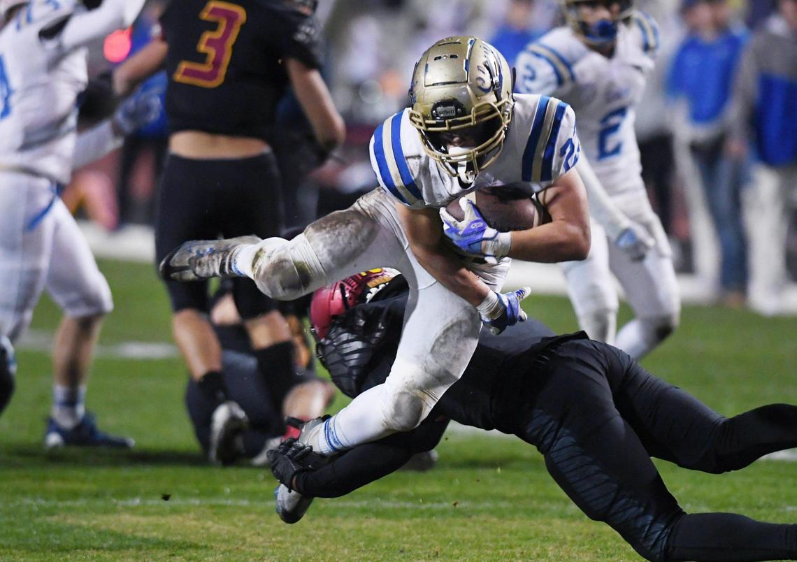 Clovis High’s Roman Moreno, top, is stopped by Clovis West’s David Cummings, bottom, in first quarter action of a central Section DI quarterfinal Thursday, Nov. 10, 2022 in Clovis.