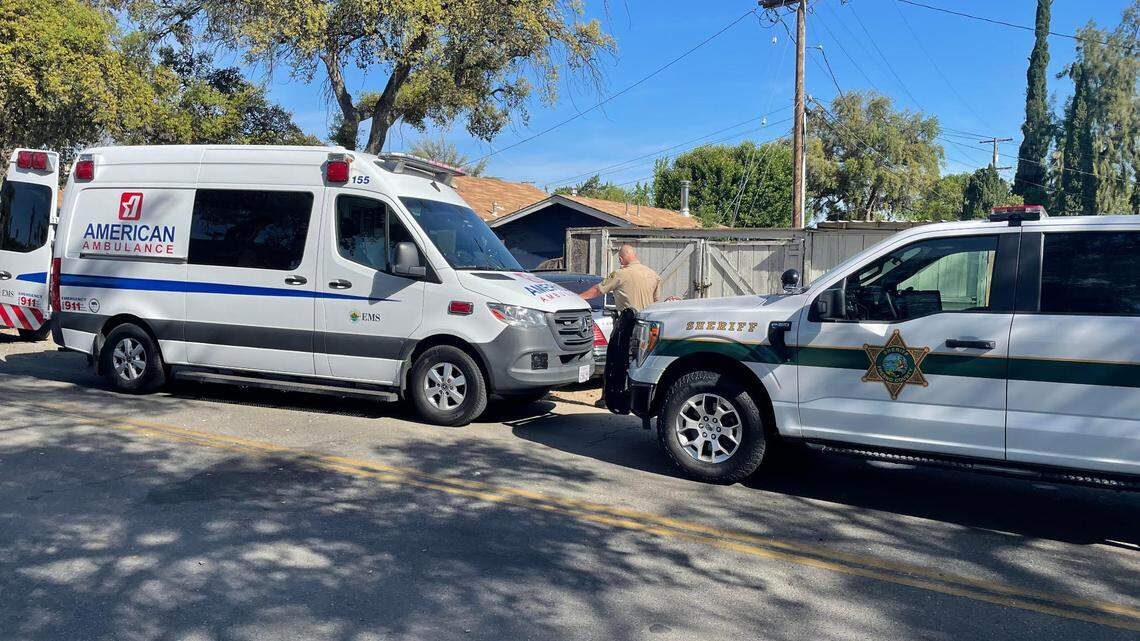 A Fresno County Sheriff’s deputy investigates a fatal accident in central Fresno where a car fell on a man doing mechanical repairs on Sunday, April 23, 2023.