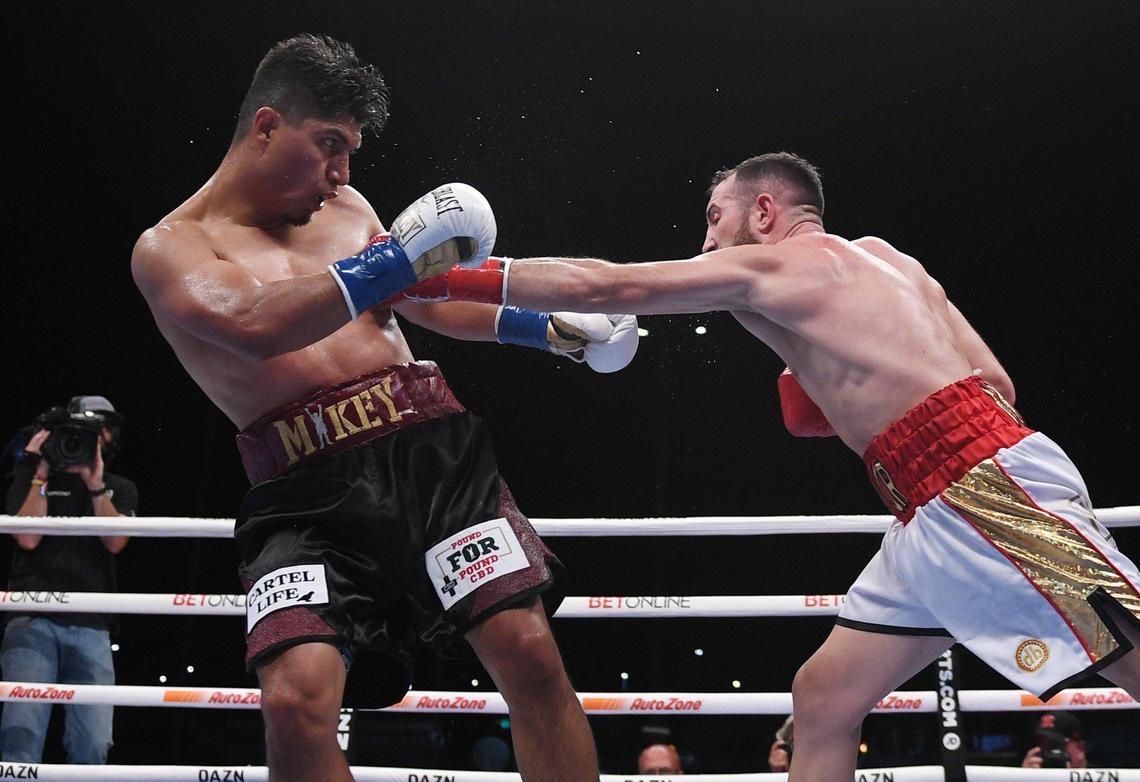 Mikey Garcia, left, takes a blow from Sandor Martin, right, in the welterweight main event held at Chukchansi Park, Saturday, Oct. 16, 2021 in Fresno.