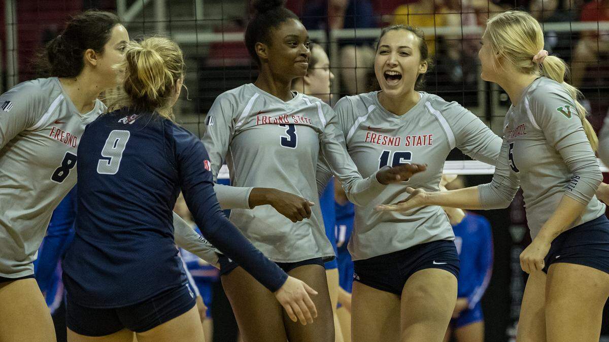 Fresno State volleyball players including Kava Durr (30) and Jessica Gilbert (16) celebrate a point during a match this season. The Bulldogs have advanced to the second round of the National Invitaitonal Volleyball Championship.