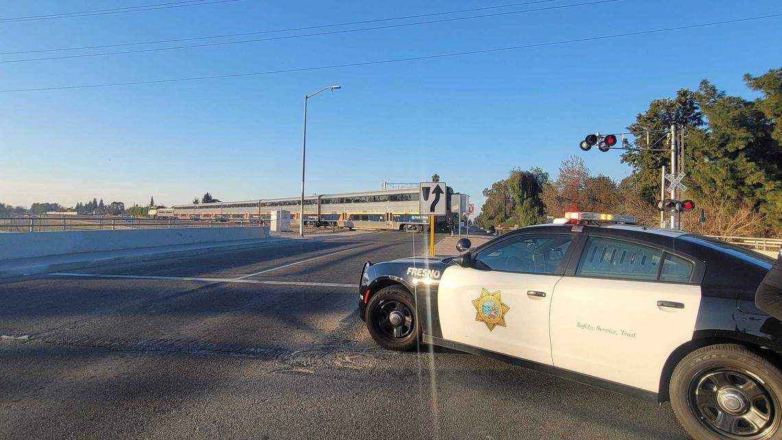 Palm Avenue at Dakota Avenue is closed off by a police cruiser after a pedestrian was struck by a train Monday, Feb. 28, 2022, in Fresno, California.