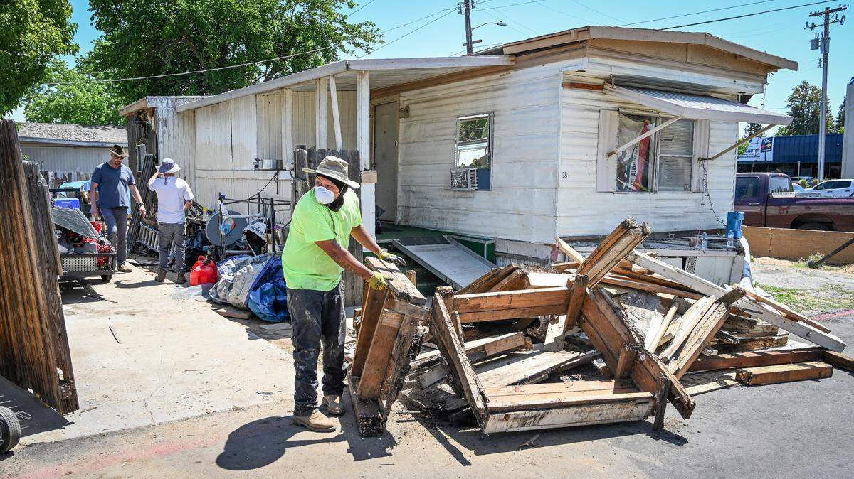 A crew begins dismantling sections of a mobile home in the Trails End Mobile Home Park in Fresno on Monday, May 2, 2022.