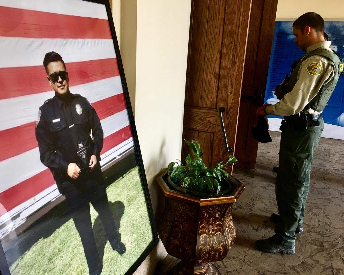 A photo of Lemoore Police Officer Jonathan Diaz in the lobby of Saint Peter Prince of the Apostles Catholic Church in Lemoore during his funeral mass Nov. 15, 2019.