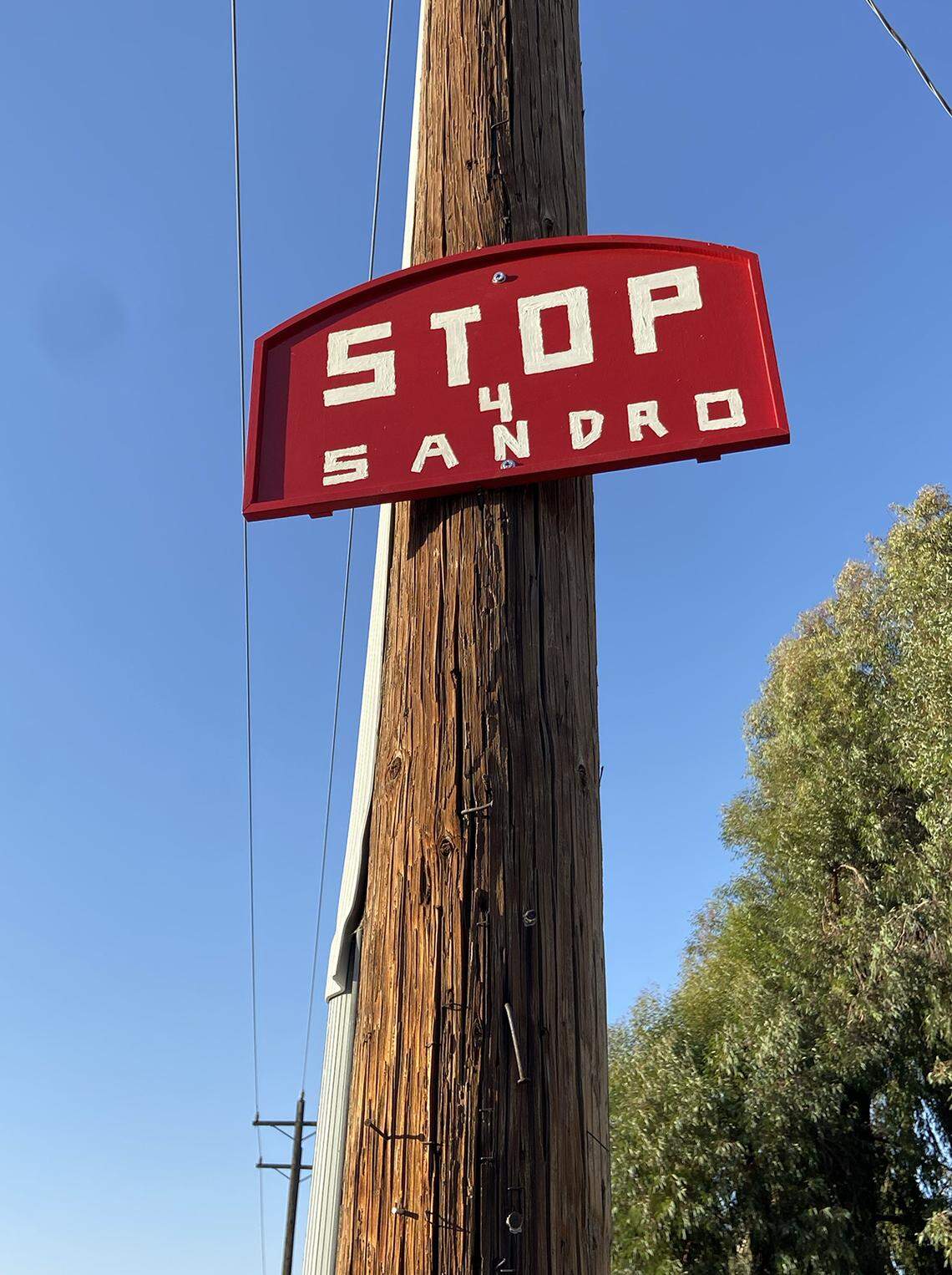 A handmade stop sign honoring Sandro Lazo is seen at the intersection of Fowler Avenue and Perrin Road in Fresno County near the outskirts of Clovis. Lazo died while riding his bike during the early evening of Aug. 8. Grieving family members and friends have pleaded with city and county leaders to install a stop sign and reduce speed limits.