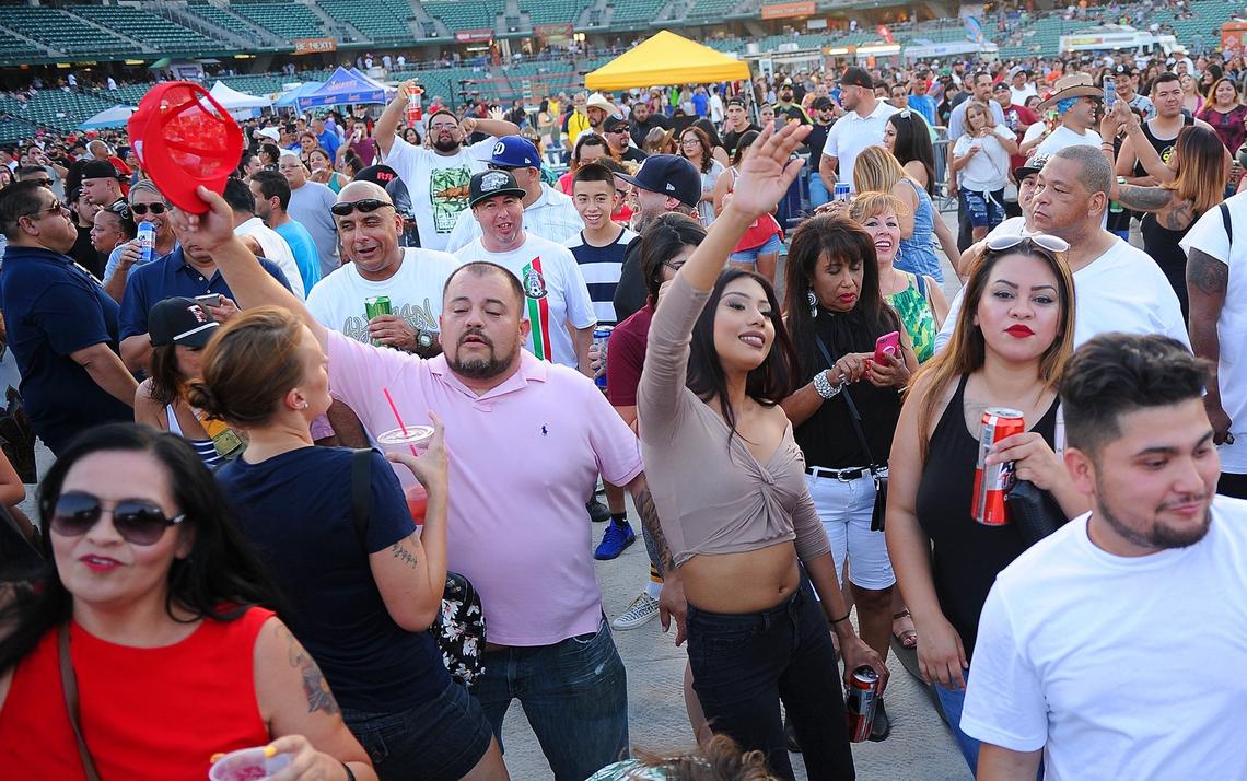 The crowd dances before the Taco Truck Throwdown 8 taco-eating contest Friday night, July 20, 2018 in Fresno.