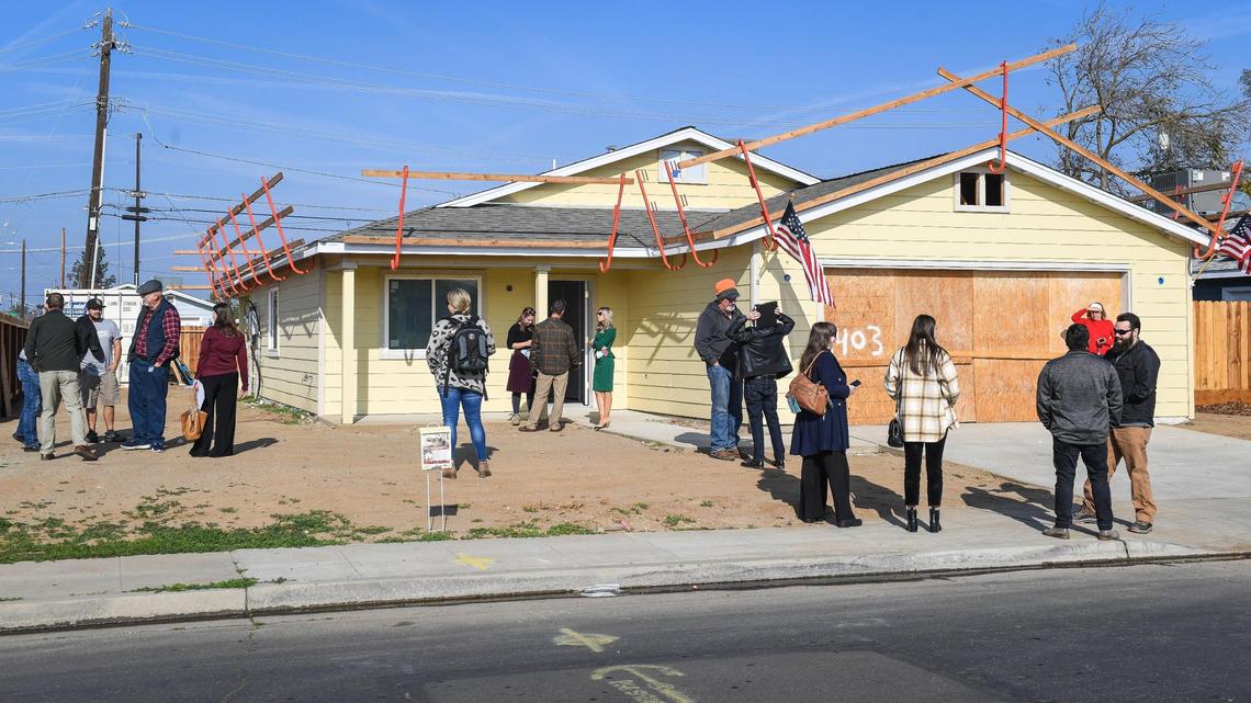 City of Clovis and Habitat for Humanity Greater Fresno Area officials wait outside an unfinished Habitat for Humanity home build in Clovis before announcing the family selected for the home on Wednesday, Dec. 8, 2021.