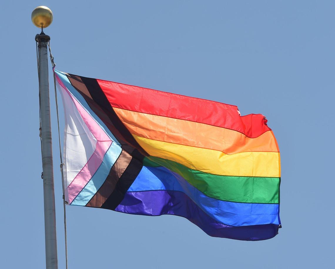 The Pride flag waves in the breeze over Fresno City Hall, after it was raised during a ceremony, Friday June 11, 2021.