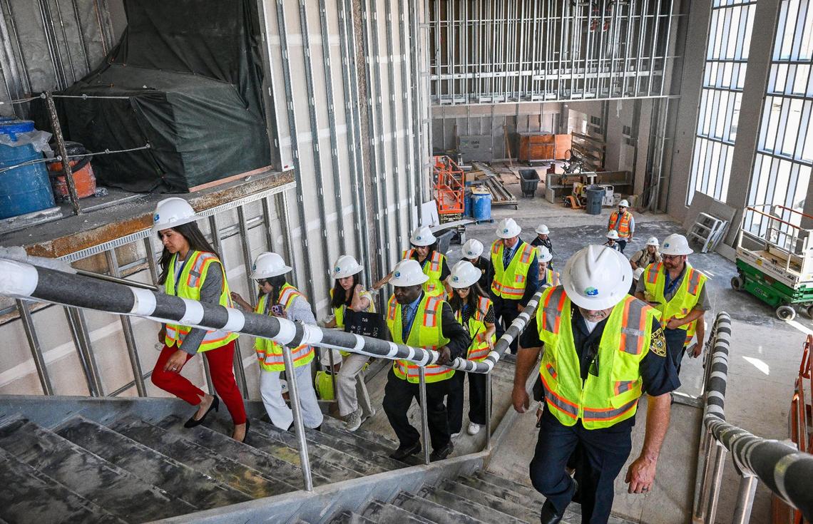 Fresno city councilmembers, officials, media and VIPs climb the stairs to the second floor of the new terminal wing under construction at Fresno Yosemite International Airport on Wednesday, April 23, 2025.