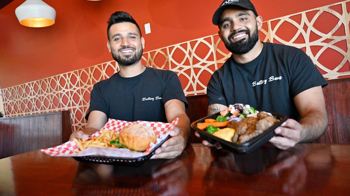 Harpreet Singh, left, and Saab Singh, right, lifelong friends, have opened two restaurants side by side, Buttery Buns and Zeus Fresh Mediterranean, with a shared dining room just south of Fresno at Highway 99 and North Avenue. Photographed Wednesday, June 21, 2023.