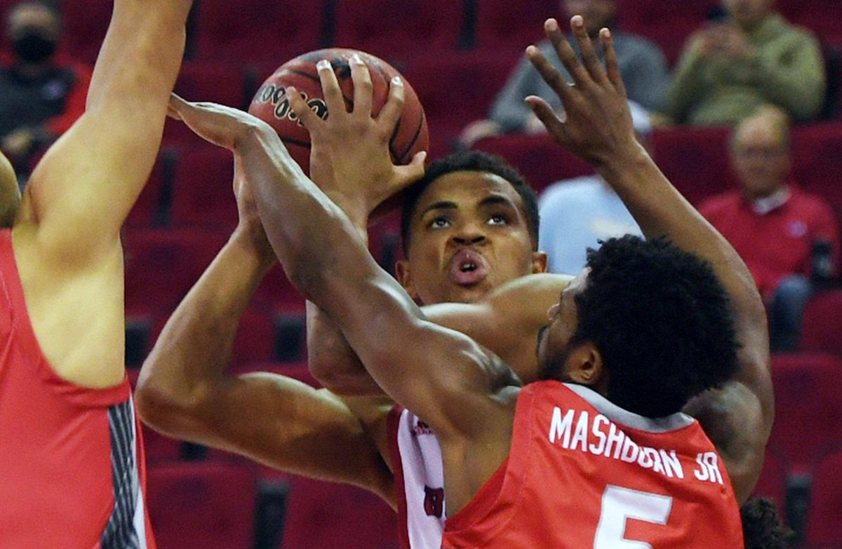 Fresno State’s Orlando Robinson, center, is fouled, covered by New Mexico’s Jay Allen- Tovar, left, and Jamal Mashburn Jr, right, Monday, Feb. 28, 2022 in Fresno. Fresno State led 39-31 at the half.
