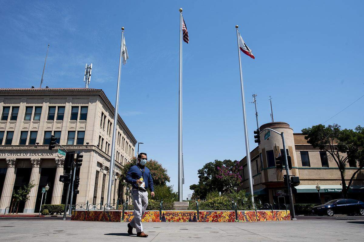People walk through Bob Hart Square in downtown Merced, Calif.
