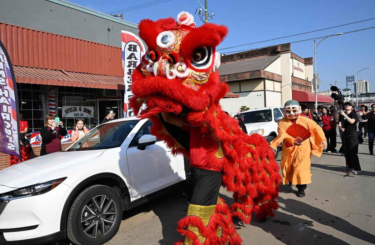 The Chinese New Year Lion Dancers walk along Kern Street visiting various businesses to welcome good luck and prosperity for the coming year Saturday morning, Jan. 25, 2025 in Fresno’s Chinatown.