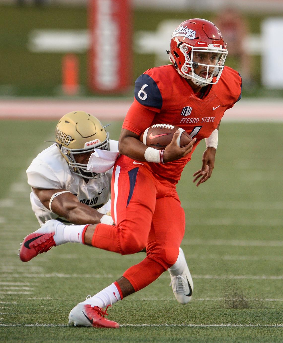 Fresno State quarterback Marcus McMaryion scrambles away from an Idaho defender in a 79-13 rout of Idaho at Bulldog Stadium on Saturday, Sept. 1, 2018. McMaryion completed 19 of 26 passes for 207 yards.