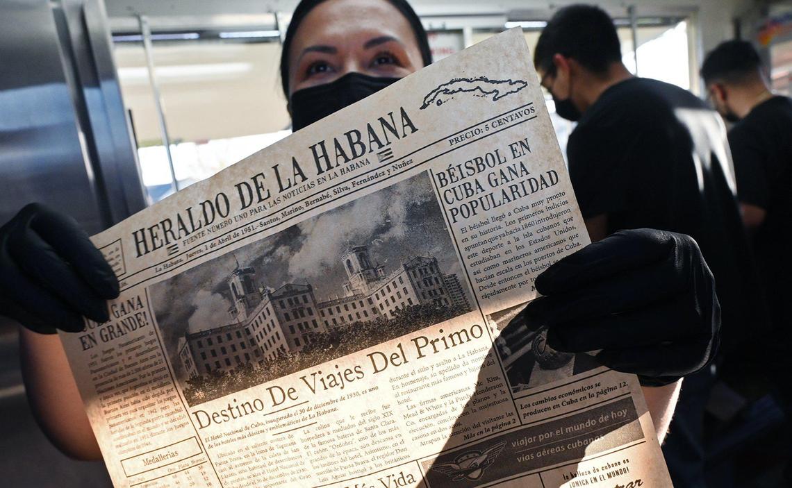 Niermin Saldana holds up a replicated Cuban newspaper printed as food wrappers used for the Cuban food she and her husband serve at their new food truck Havana Cafe Wednesday, March 16, 2022 in Fresno. Lazaro and Niermin Santana have opened a food truck staffed by family members which specializes in Cuban food and coffee.