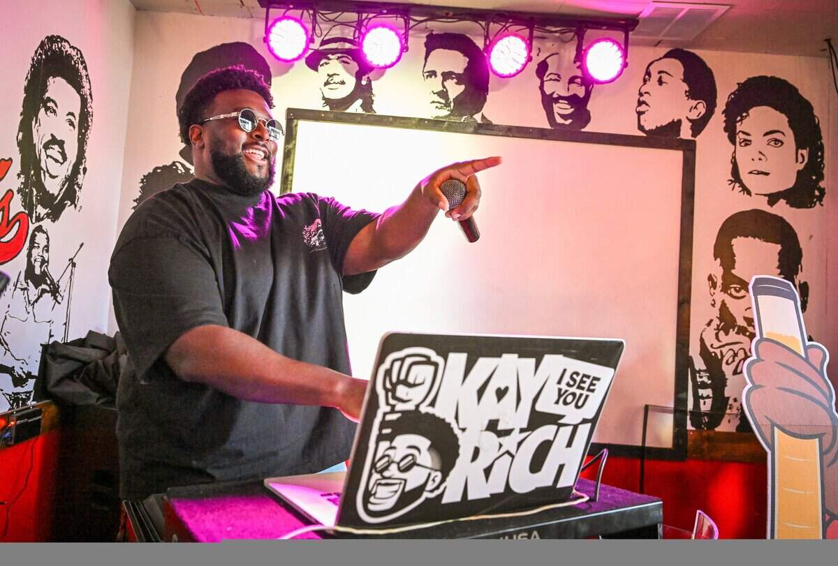 DJ Kay Rich plays music and calls out celebrations for brunch-goers at Kocky's Bar & Grill in downtown Fresno during their Butta Brunch on Sunday morning, Aug. 10, 2025.