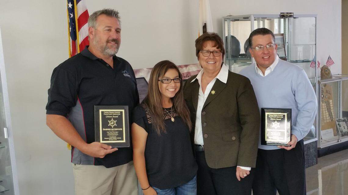 Brian Grabowski, an ocularist from Visalia who made a prosethic eye for gunshot wound victim Brianna Ramirez of Parlier, holds a plaque given to him by Fresno County Sheriff Margaret Mims in September 2015. Grabowski died Sunday, Sept. 2, 2108 in a boating accident on the Colorado River. From left to right, Grabowski, Ramirez, Mims and Mark Schultz.