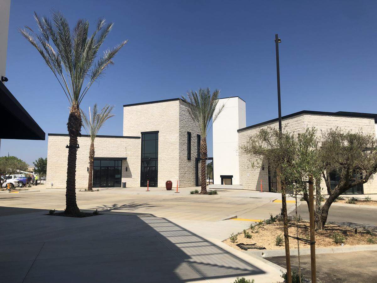 The Avenue, part of the Heritage Grove masterplanned community in Clovis, strives to offer an upscale, mix-use experience in the Fresno area that’s void of repeated, nearby businesses. Two of the buildings at The Avenue have a white stone exterior.