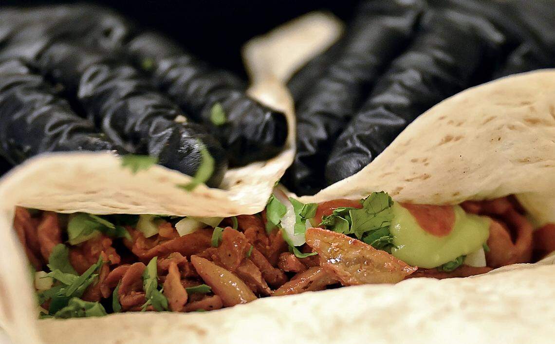 An al pastor burrito is wrapped up for a customer at Armando Arias Jr.'s new Tacos El Cabezon, a food truck parked at the corner of Shaw and Marks avenues. Photographed Wednesday, Sept. 24, 2025 in Fresno.