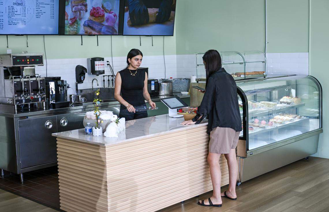 Arpi Keymetlyan holds a customer at Lodei Bakery & Cafe, an Armenian family-owned bakery on the northeast corner of Palm and Bullard.