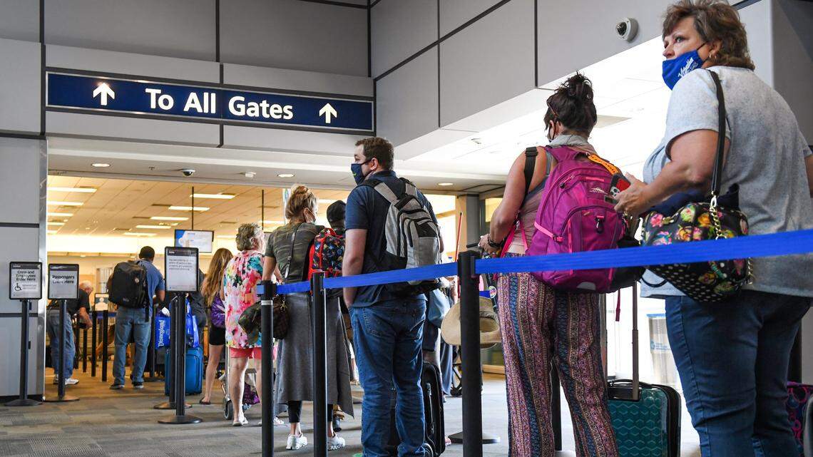 Passengers wait in line to go through the TSA security checkpoint at Fresno Yosemite International Airport in this June 2021 file photo. Fresno’s airport set a record of more than 2.4 million inbound and outbound passengers in 2023. It was the second straight year in which the number of passengers exceeded 2 million.