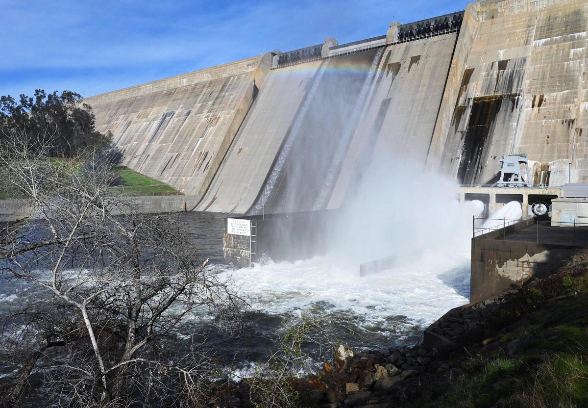 A rainbow is seen as water flows are increased from Friant Dam Friday, Jan. 6, 2023 near Friant.