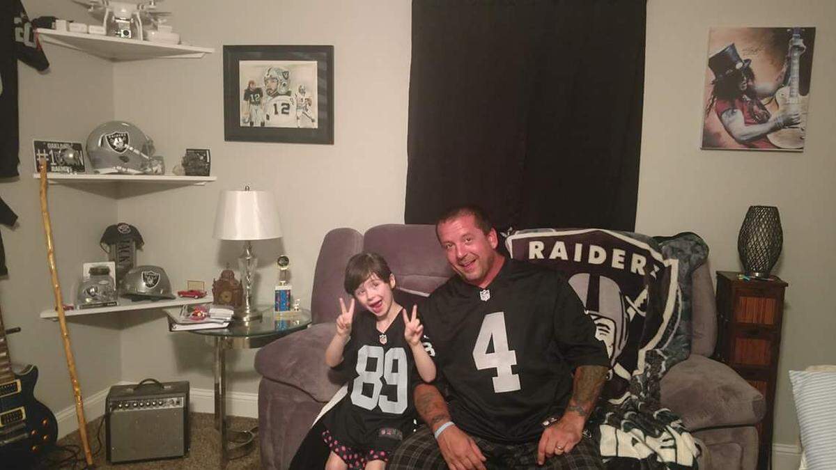 Brooklyn Reiter of Myrle Beach, S.C., poses with her dad, John. Both are die-hard Raiders and Derek Carr fans. Last week, she received a signed autograph picture and a letter of words of encouragement.