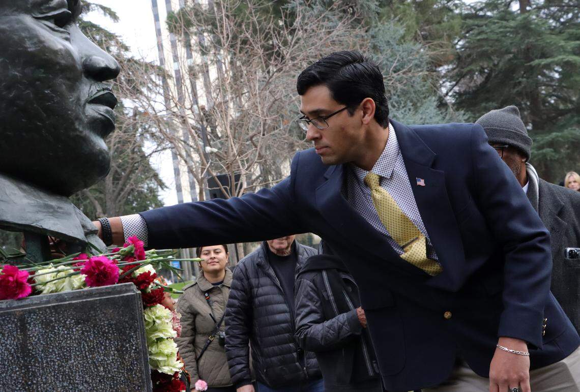 Bryce Herrera, a District 2 candidate for the Fresno County Board of Supervisors, places a carnation during a Martin Luther King Jr. ceremony on Jan. 12 at Courthouse Park.