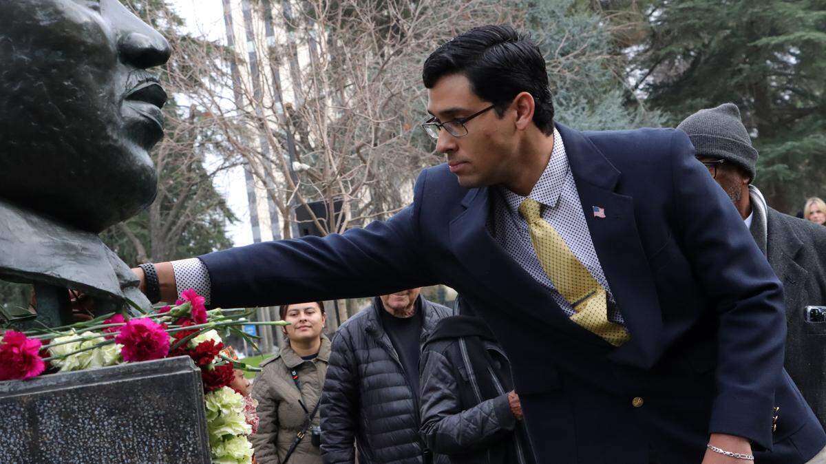 Bryce Herrera, a District 2 candidate for the Fresno County Board of Supervisors, places a carnation during a Martin Luther King Jr. ceremony on Jan. 12 at Courthouse Park.