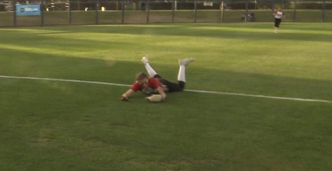 Hanford left fielder Maddie Benedict makes a diving catch during the Central Section Division II championship game on Friday, May 27, 2022.
