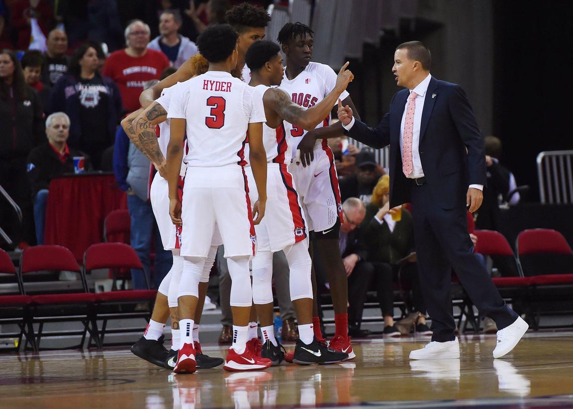 Fresno State coach Justin Hutson, right, talks to the team during a timeout against Boise State Saturday, Jan. 25, 2020 in Fresno.