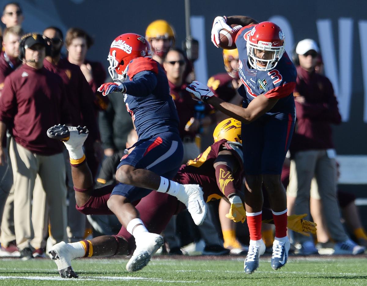 Fresno State’s KeeSean Johnson, right, tries to evade a tackle against Arizona State during their game at the Mitsubishi Las Vegas Bowl at Sam Boyd Stadium in Las Vegas on Saturday, Dec. 15, 2018.