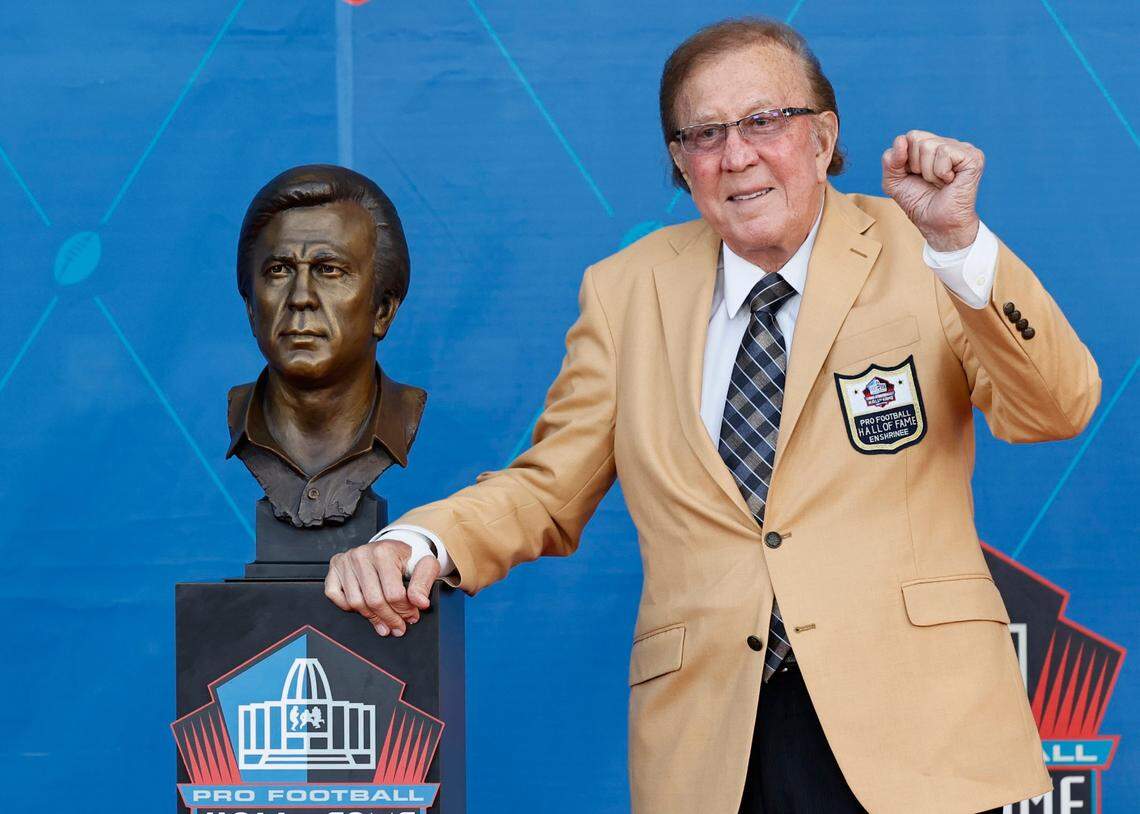 Tom Flores, a member of the Pro Football Hall of Fame Class of 2021, poses with his bust during the induction ceremony at the Pro Football Hall of Fame, Sunday, Aug. 8, 2021, in Canton, Ohio.