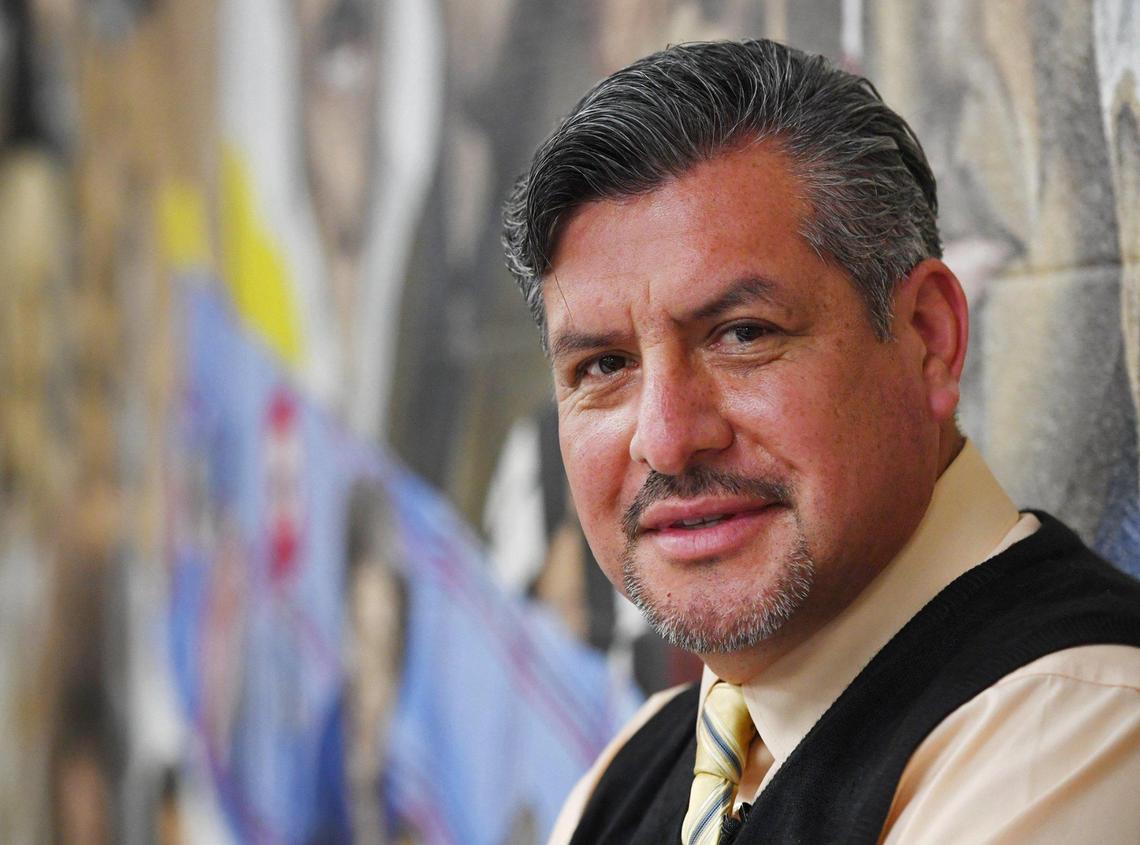 Muralist and art teacher Jose Jesus Elias poses in front of his Americanos mural, which features prominent Latinos in a classroom at West Hills Community CollegeÕs North District campus in Firebaugh Thursday, March 10, 2022. The mural and the classrooms and building where it is located will be razed to make way for the new college center.