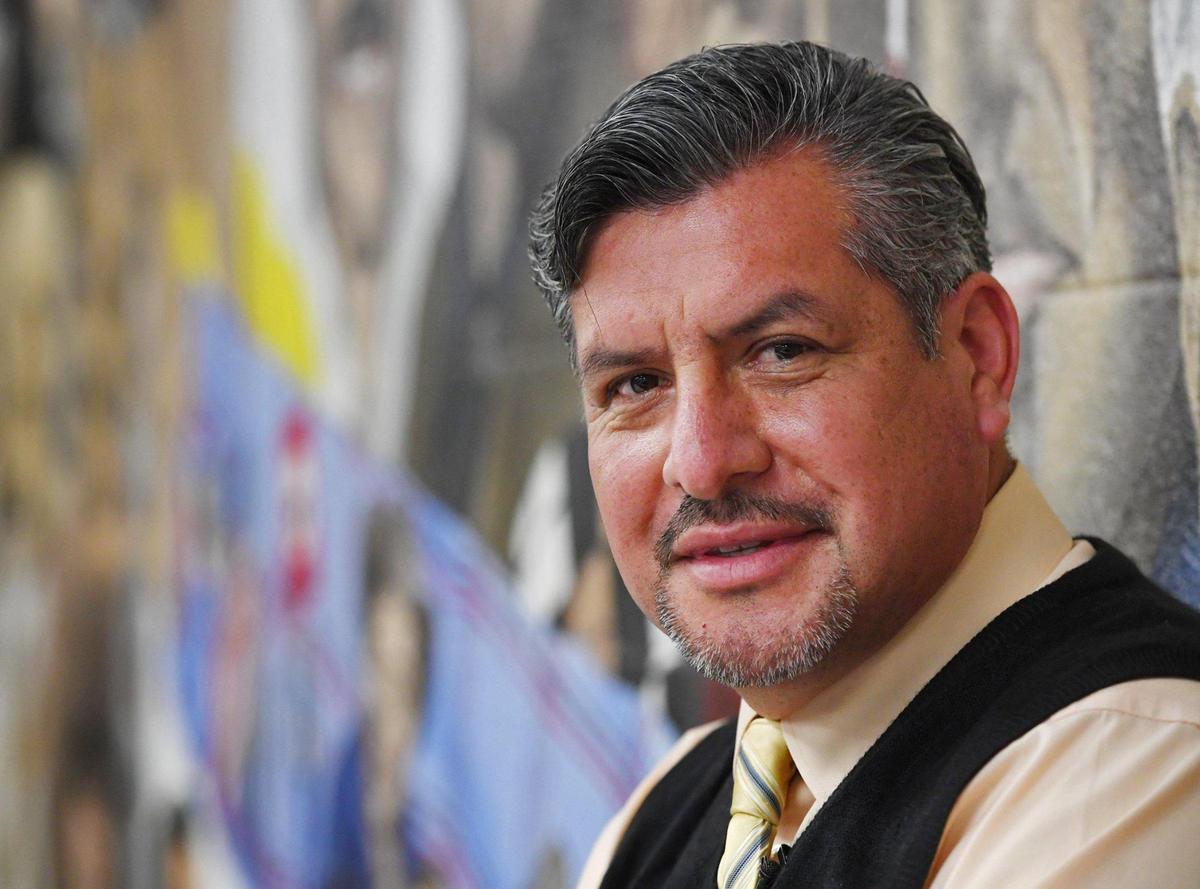 Muralist and art teacher Jose Jesus Elias poses in front of his Americanos mural, which features prominent Latinos in a classroom at West Hills Community CollegeÕs North District campus in Firebaugh Thursday, March 10, 2022. The mural and the classrooms and building where it is located will be razed to make way for the new college center.