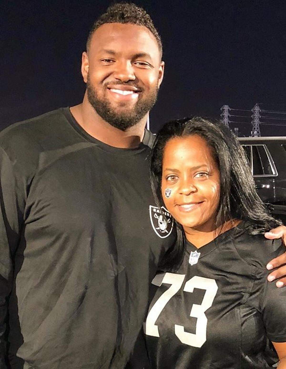 Maurice Hurst Jr. takes a photo with his mom, Nicole Page.