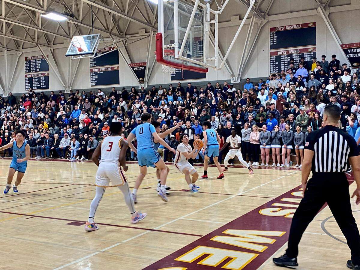 Clovis West guard Issac Martinez drives to the basket against Clovis North in a high school boys basketball game in Fresno, California on Friday, Jan. 27, 2023.