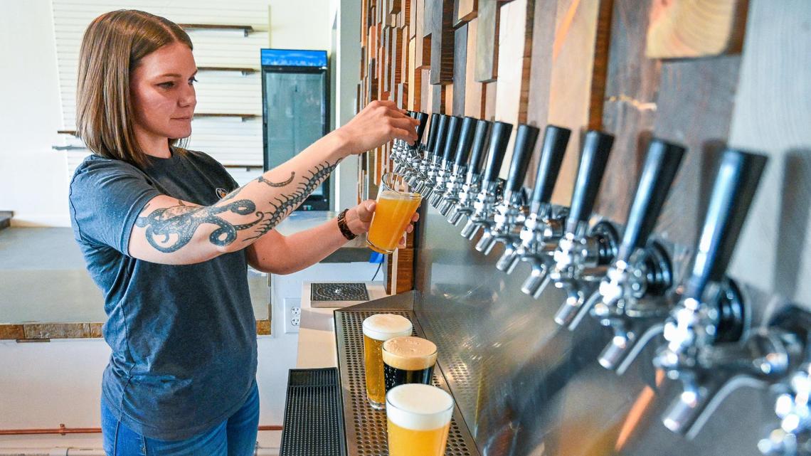 Sarah Lisitsin pours beers at Summer Fox Brewing Company’s new location on Clovis Avenue in Clovis on Wednesday, April 6, 2022.