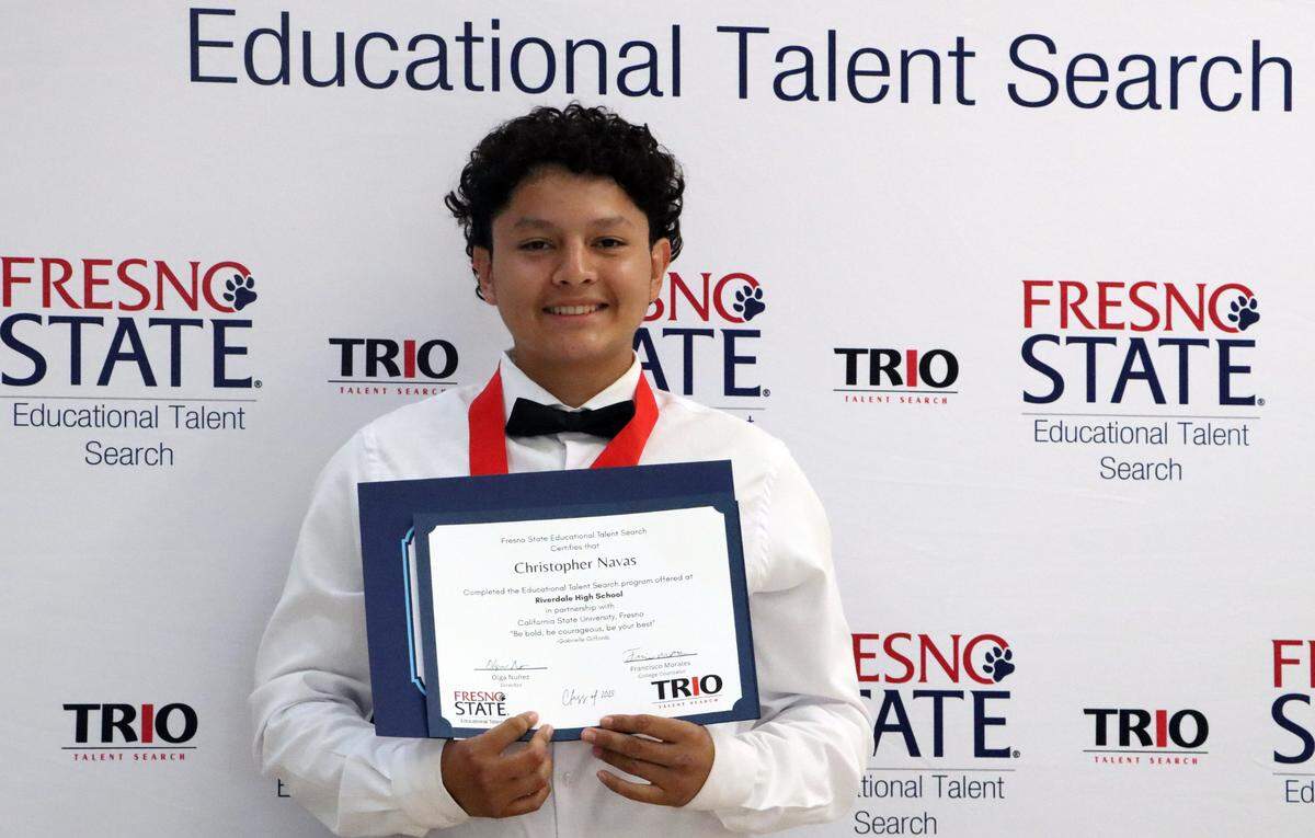 Riverdale High TRIO participant Christopher Navas, posing at a program graduation on May 14, 2025, credits the program with getting him more involved in school.