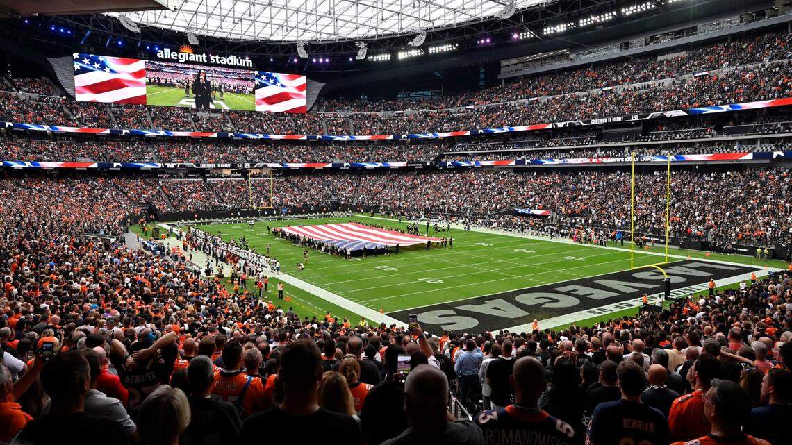 Spectators stand during the national anthem before an NFL football game between the Las Vegas Raiders and the Denver Broncos at Allegiant Stadium Sunday, Oct. 2, 2022, in Las Vegas. 