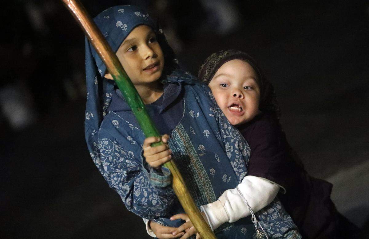 Two boys participate in a posada organized at St. Anthony Mary Claret Church in southeast Fresno on Dec. 18, 2023.